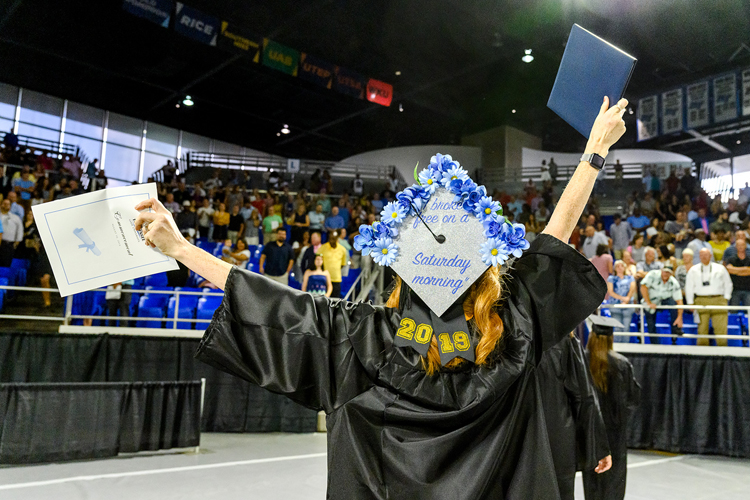 A member of MTSU’s Class of 2019, wearing a customized mortarboard reading “I broke free on a Saturday morning!”, proudly holds her new university degree and program as she leaves Murphy Center Saturday, Aug. 10, after the university’s summer 2019 commencement ceremony. MTSU awarded 817 degrees during the event to 603 undergrads and 214 graduate students. (MTSU photo by J. Intintoli)