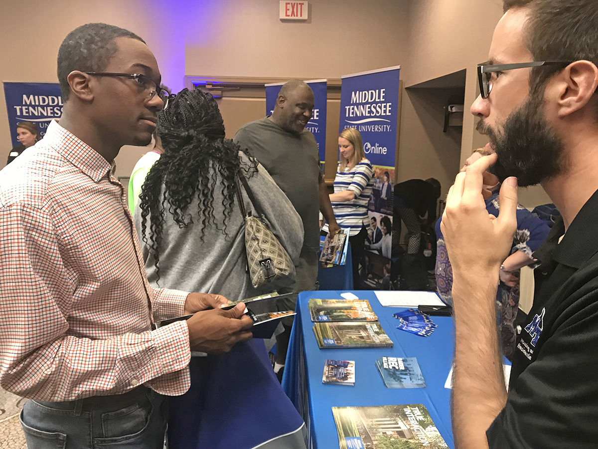 Caleb Hill, left, a senior at Jefferson County International Baccalaureate in Birmingham, Ala., learns more about MTSU Housing and Residential Life from Dylan Ruffra Thursday, Sept. 26, during the True Blue Tour visit at the Marriott in Birmingham. (MTSU photo by Randy Weiler)