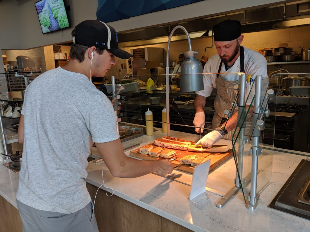 A student grabs a sandwich from Farmers Market, an all-you-care-to-eat dining hall inside the Student Union Building, in this file photo. 