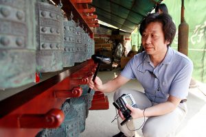Music archaeologist Li Youping performs on the bronze bells that are thought in Chinese culture to harmonize heaven and earth. He will lecture and perform Sept. 26 at MTSU’s Miller Education Center. (Photo submitted)