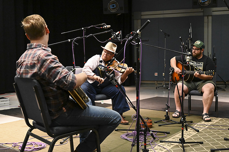 Multi-instrumentalist Trenton "Tater" Caruthers of Cookeville, Tenn., center, fiddles along with accompanists Connor Vlietstra, left, on banjo and Corbin Hayslett on guitar during a recording session for his old-time fiddle music in the university's Studio A in the Bragg Media and Entertainment Building. MTSU's Center for Popular Music is creating its first CD on campus for its Grammy-winning Spring Fed Records label to capture Caruthers and fellow old-time fiddler Austin Derryberry of Unionville, Tenn., an August 2019 MTSU grad. (MTSU photo by Kimi Conro)