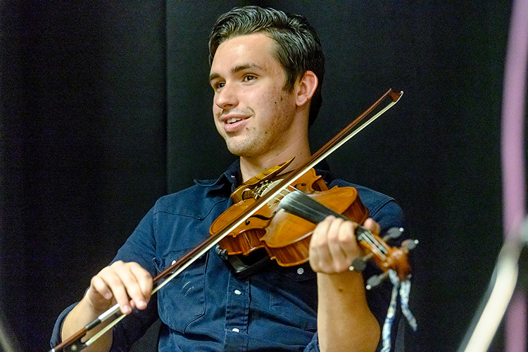 Austin Derryberry of Unionville, Tenn., an August 2019 MTSU audio production graduate and award-winning multi-instrumentalist, smiles during a recording session for his old-time fiddle music in the university's Studio A in the Bragg Media and Entertainment Building. MTSU's Center for Popular Music is creating its first CD on campus for its Grammy-winning Spring Fed Records label to capture Derryberry and fellow old-time fiddler Trenton "Tater" Caruthers of Cookeville, Tenn. (MTSU photo by J. Intintoli)
