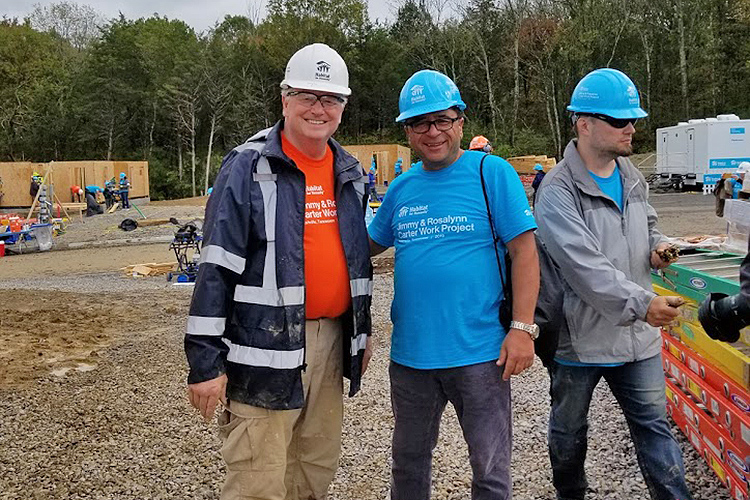 Murat Arik, right, director of MTSU’s Business and Economic Research Center, and Tom Wallace, an associate vice president in MTSU’s Information Technology Division, pose for a photo Oct. 7 at the site of the Carter Work Project 2019 Habitat for Humanity build in Nashville, Tenn. (Submitted photo)