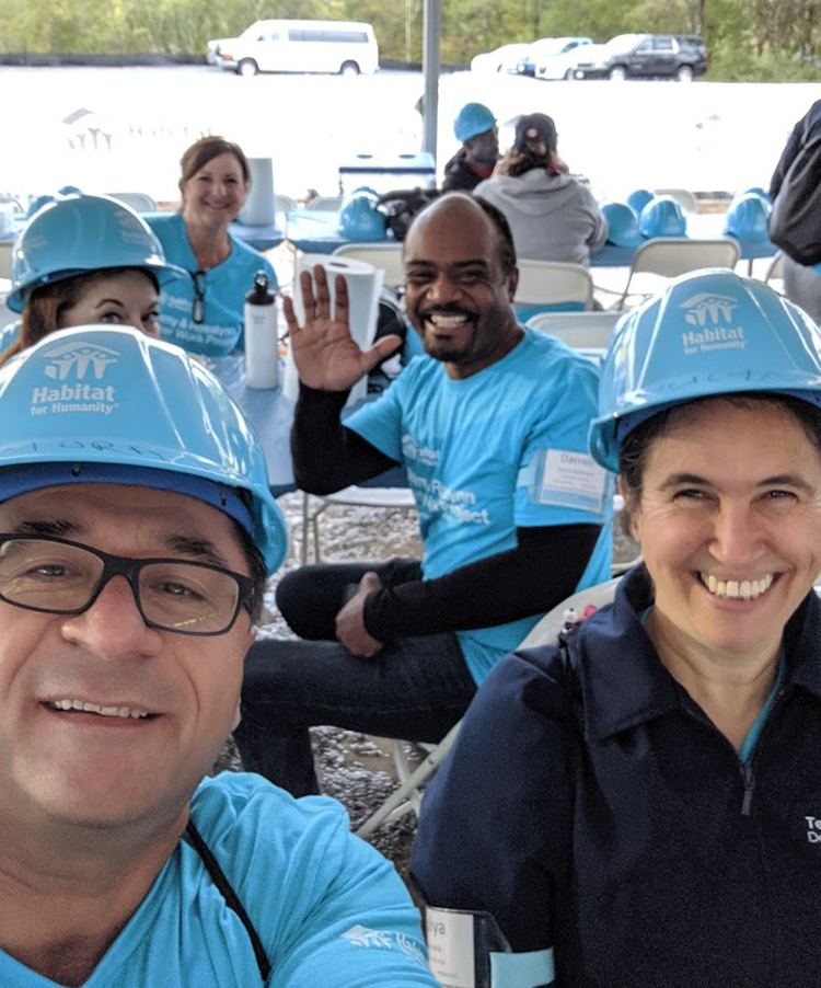 Murat Arik, left, director of MTSU’s Business and Economic Research Center, and his wife, Hulya, right, pose for a selfie with other volunteers Oct. 7 at the site of the Carter Work Project 2019 Habitat for Humanity build in Nashville, Tenn. (Submitted photo)