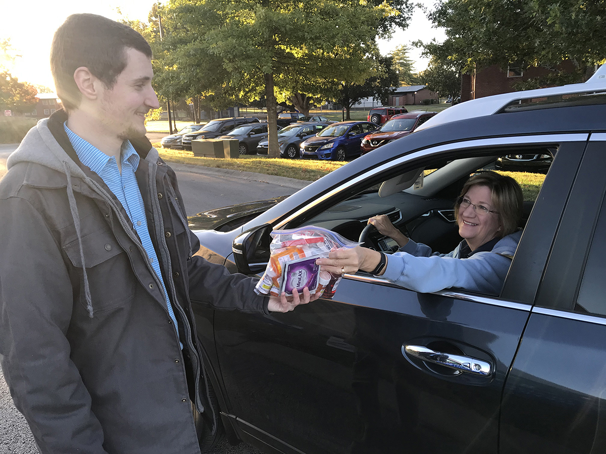 Tyler Hollis, left, a fourth-year Lipscomb University College of Pharmacy student, collects unwanted medications from Tammy Howell, a secretary in the MTSU Department of Biology, Thursday, Oct. 24, during the fall Drug Take-Back Day at the Campus Pharmacy Drive-Thru. More than 83 pounds was collected during the 5½-hour drive. (MTSU photo by Randy Weiler)