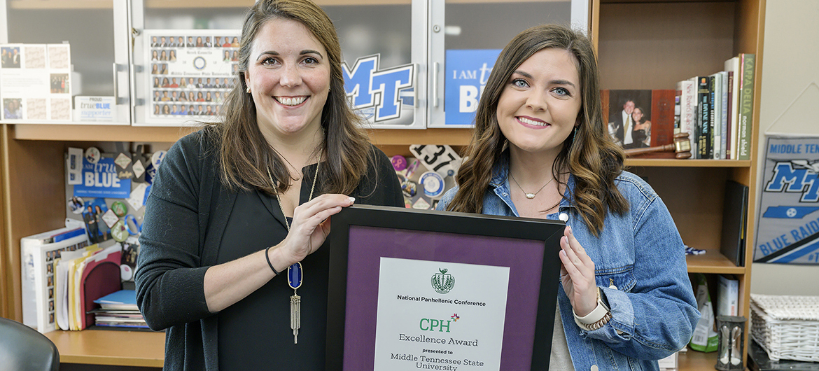 Sara Sparks, right, MTSU College Panhellenic Council president, and Leslie Merritt, director of the Office of Fraternity and Sorority Life, pose with the College Panhellenic Excellence Award from the National Panhellenic Conference. MTSU is one of only 26 institutions in the country to receive the honor from the sorority advocacy organization. (MTSU photo by Andy Heidt)