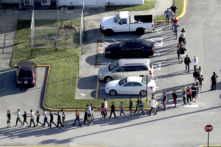 Police help students and staff evacuate Marjory Stoneman Douglas High School in Parkland, Fla., Feb. 14, 2018, after a shooter opened fire on the campus. Three staffers from the South Florida Sun Sentinel will discuss the paper’s 2019 Pulitzer Prize for public service journalism at MTSU Tuesday, Oct. 22. (Mike Stocker/South Florida Sun-Sentinel)