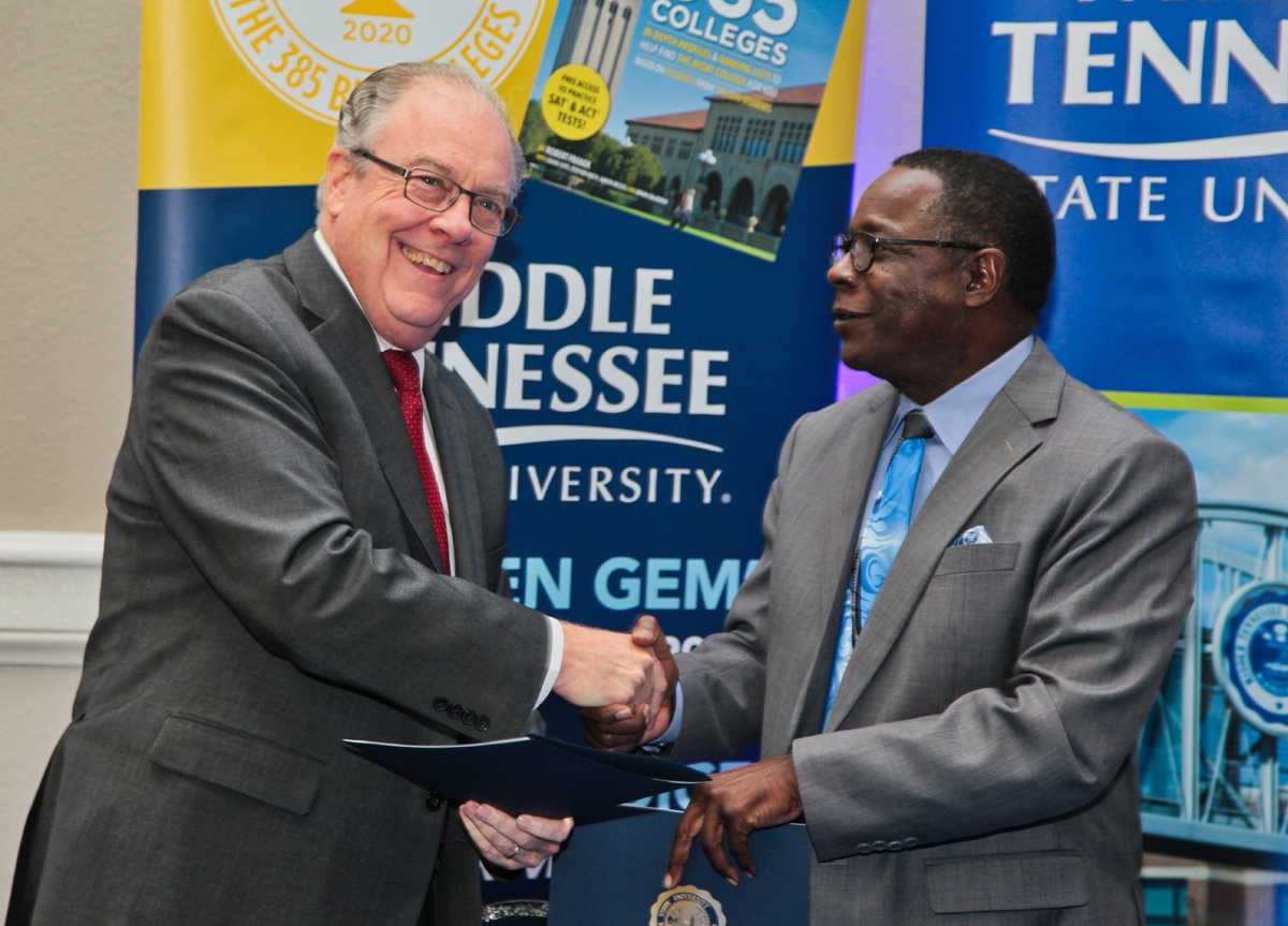 Presidents Jerry Faulkner, left, of Vol State and Sidney A. McPhee of MTSU shake hands after signing an “MTSU Promise” to Vol State to ease the transition from college to university Oct. 22 at the Millennium Maxwell House Hotel in Nashville. Through its existing Guaranteed Transfer Scholarship Program, MTSU will provide aid for qualifying Vol State students who transfer to MTSU in the amount of $3,000 per year for two years, or a maximum of four semesters, based on achievement of a 3.0 GPA. (MTSU photo by David Foster)
