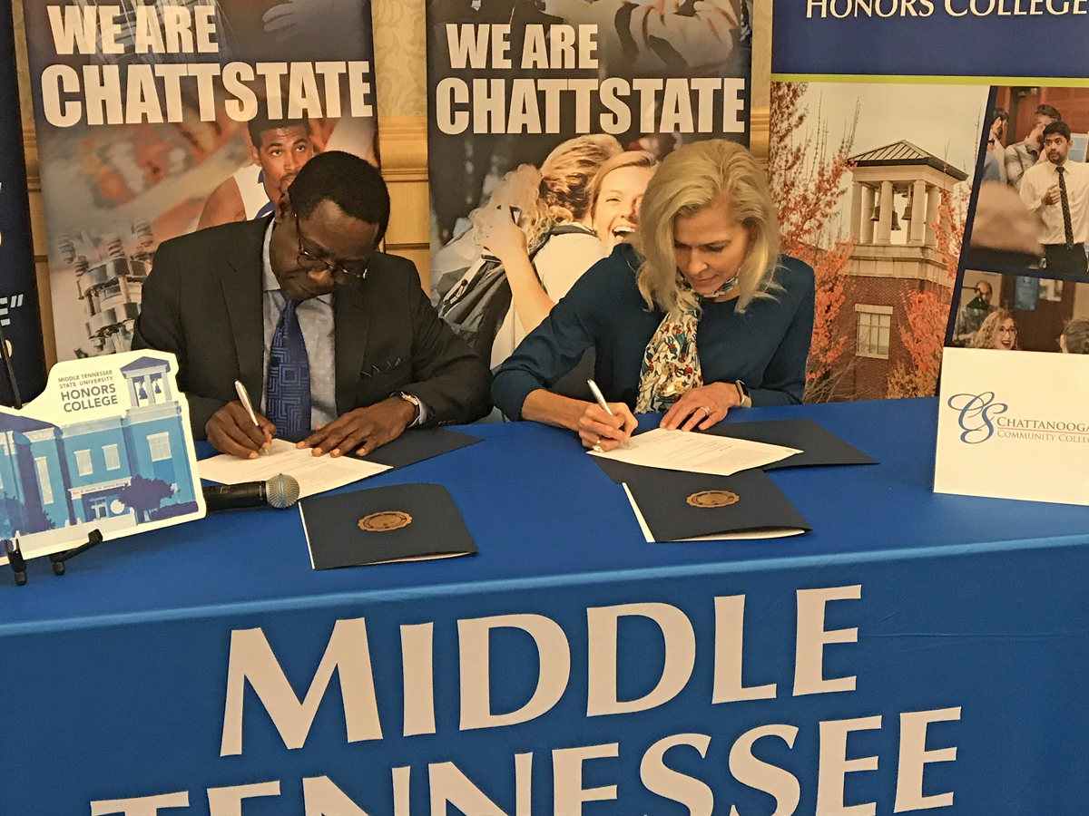 Presidents Sidney A. McPhee, left, of Middle Tennessee State University Rebecca Ashford of Chattanooga State Community College sign an agreement marking the “MTSU Promise” to Chattanooga State, the eighth such pathway established for students with associate degrees to move seamlessly to the four-year university. The signing occurred Oct. 29 at the Chattanooga Convention Center during MTSU’s True Blue Tour visit to the Chattanooga area to recruit students and court counselors and community college staff. (MTSU photo by Randy Weiler)