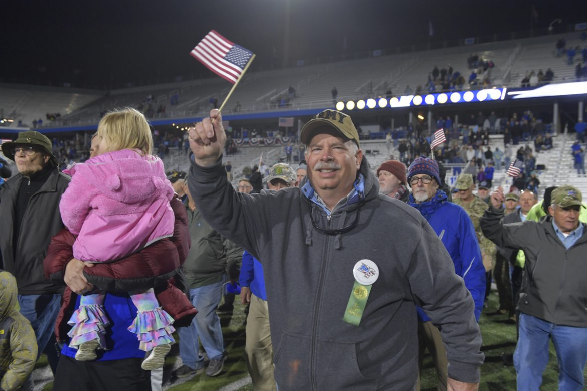 U.S. Army veterans walk across Horace Jones Field in Floyd Stadium at halftime to the Army fight song played by the MTSU Band of Blue in November 2019 as part of the 38th Salute to Veterans and Armed Forces game activities. (MTSU file photo by James Cessna)