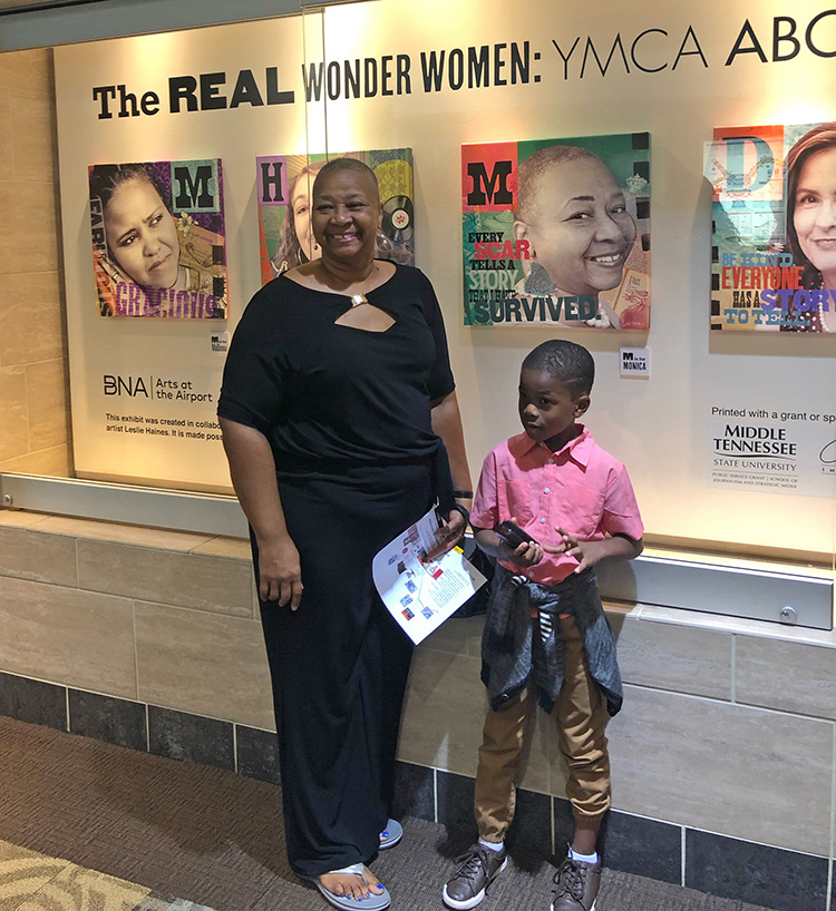 Breast cancer survivor Monica McGuire is shown with family friend Harper Fields at the Nashville International Airport in September for a special reception featuring the exhibit of MTSU visual arts professor Leslie Haines, also a breast cancer survivor and who created a series of 12 portrait illustrations of fellow survivors titled "The Real Wonder Women: YMCA ABC Program" that will be on display in Concourse A of the airport until late February. (Submitted photo)