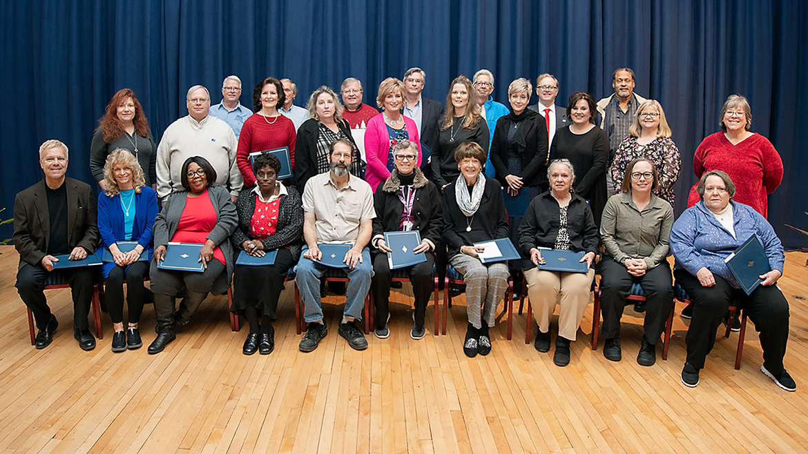 MTSU employees honored for 25 years of service to the university pose with pins and certificates recognizing their work at the university’s annual Service Award Luncheon, held Dec. 5 in the James Union Building. More than 230 faculty and staff members were saluted at the 2019 event for their years of service. Seated on the front row are, from left, Jim Piekarski, Department of Recording Industry; Jana Hinz, University College; Sue Alexander, Telecommunications Services Department; Melbra Simmon, Education Resource Channel/Center for Educational Media; Rick Rishaw, Department of Art and Design; Jette Halladay, Department of Theatre and Dance; Margaret Fontanesi-Seime, Department of Social Work; Irma Melton, Department of Media Arts; Dana Fuller, Department of Psychology; and Kathy Kano, Office of the Vice Provost for Student Affairs. Standing on the middle row are, from left, Melodie Phillips, Department of Marketing; Paul Kline, Department of Chemistry; Betsy Williams, Office of Development and Advancement Services; Joan Raines, Department of University Studies; Angie Price, Office of the University Provost; Lori Pugh, Facilities Services Department; Janine Brink, Office of the Vice President for Business and Finance; Lisa Jones, Human Resource Services; Teri Davis, Department of Psychology; and Barbara Money, University Housing and Residential Life. Standing on the back row, from left, are Norman Buck, Energy Services Department; Earl Bogle, Construction Administration Department; John Schmidt, Information Technology Division; David Carleton, Department of Political Science and International Relations; Bill Whitehill, Department of Health and Human Performance; Preston MacDougall, Department of Chemistry; and Les Mayberry, Energy Services Department. (MTSU photo by James Cessna)
