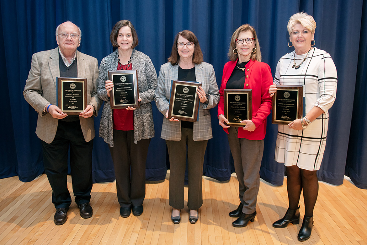 MTSU employees honored for 35 years of service to the university pose with plaques recognizing their work at the university’s annual Service Award Luncheon, held Dec. 5 in the James Union Building. More than 230 faculty and staff members were saluted at the 2019 event for their years of service. From left are Bob Petersen, Department of English, and LeAnn Sensing, Financial Aid and Scholarships Office, both Murfreesboro residents; Sharon Parente of Christiana, Tenn., James E. Walker Library; and Murfreesboro residents Paula Thomas, Department of Accounting, and Connie Huddleston, College of Liberal Arts. (MTSU photo by James Cessna)