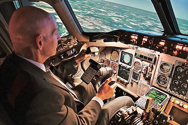 Retired Army Lt. Gen. Keith Huber, MTSU’s senior advisor for veterans and leadership initiatives, at the stick of a MD-88 aircraft simulator at Delta Airlines’ world headquarters in Atlanta. (MTSU photo by Andrew Oppmann)