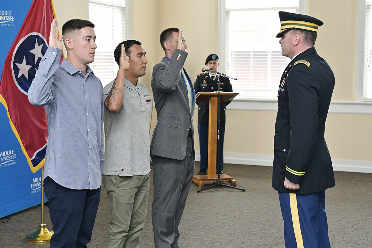 U.S. Army Lt. Col. Carrick McCarthy, right, swears in Michael Maynard, left, of Boston, Mass., Brian Acosta of St. Charles, Ill., and Joshua Smith of Lawrenceburg, Tenn., as the newest contracted cadets in the MTSU ROTC program during a ceremony in the Tom H. Jackson Building’s Cantrell Hall. McCarthy is chair of the military science program. Not pictured: Tyler Vongpanya of Murfreesboro. (MTSU photo by Andy Heidt)
