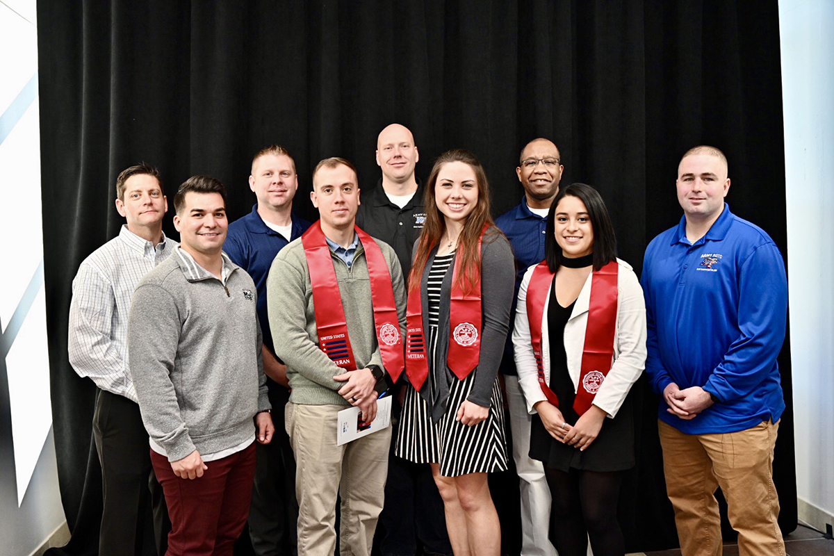 MTSU military science faculty members joined three ROTC students who received red stoles at the 15th Graduating Veterans Stole Ceremony Wednesday, Dec. 4, at the Miller Education Center on Bell Street. From left are Maj. Trint Callison, Capt. Alex Rodriguez, Sgt. 1st Class James Plack, Ethan Roberts, Master Sgt. Jay Farmer, Rachel Teufert, Capt. LaShawn Wilson, Neily Jimenez and Capt. Derrick Gessler. The cadets can wear the stoles at the Dec. 14 commencement ceremonies in Murphy Center. (MTSU photo by J. Intintoli)