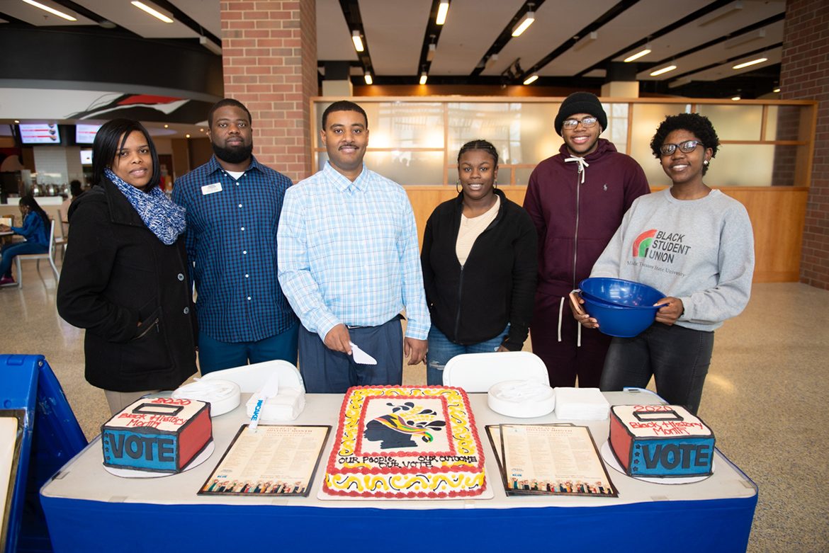 Some members of the 2020 MTSU Black History Month Committee prepare to cut the celebratory cake at the Feb. 3 kickoff event held in the Student Union atrium. Pictured, from left, are Danielle Rochelle, Chris Rochelle, Daniel Green, Daisha Green, Lamont Lockridge and Ashley Lowe. (MTSU photo by James Cessna)