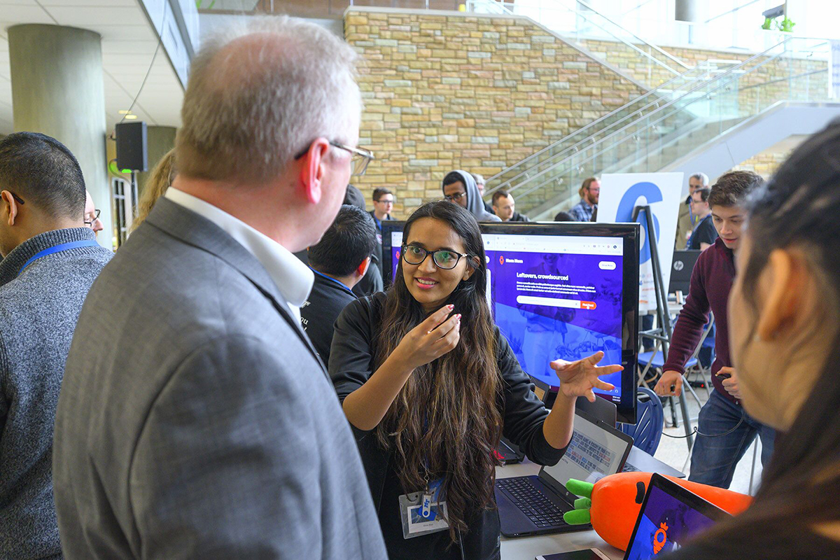 Heena Khan, 28, an MTSU computer science graduate student from Mumbai, explains her Nom/Nom team’s online free food-finding app to a judge during the fifth annual HackMT at MTSU in the Science Building Liz and Creighton Rhea Atrium Sunday, Jan. 26. (MTSU photo by Cat Curtis Murphy)