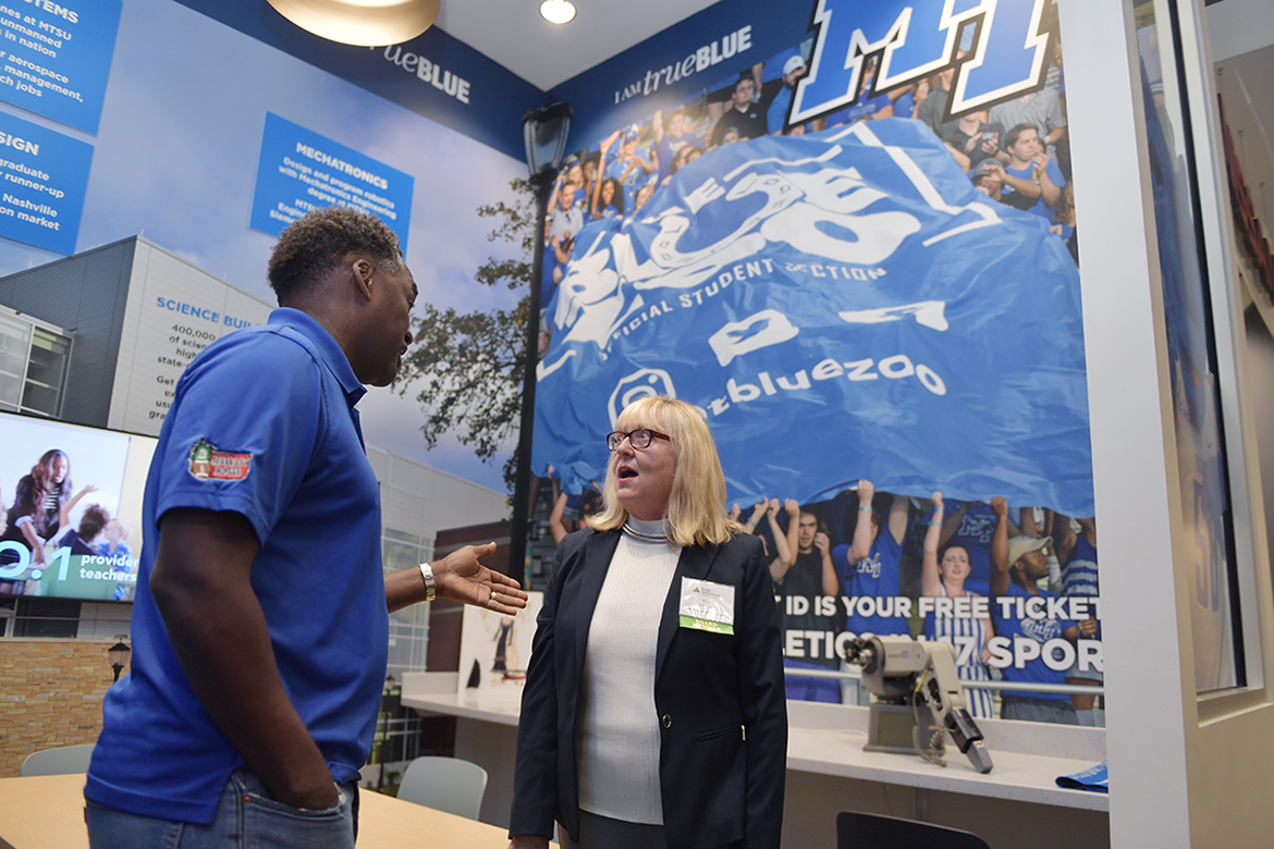 MTSU alumna, trustee and Junior Achievement of Middle Tennessee board member Pam Wright, right, chats with fellow MTSU Trustee and Vice Chairman Darrell Freeman Sr. Tuesday, Jan. 14, at the grand opening of the new JA Finance Park on Powell Place in Nashville, Tenn. The new park provides a real-world simulation for students to learn how their financial decisions regarding higher education, health care and other areas affect their personal budgets. Wright, a longtime JA supporter, funded an MTSU-branded room in the park that features popular university programs. (MTSU photo by James Cessna)