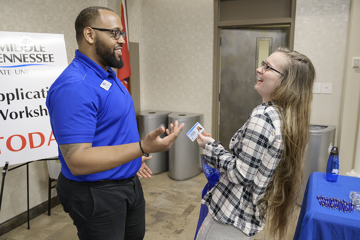 MTSU transfer coordinator Zach Thompson, left, and prospective MTSU student Tiffany Harvey share a laugh after giving her an ID card he made for her in January 2019 during the “Promise Tour” visit to Chattanooga State Community College. This year’s tour to nine campuses will begin Jan. 28 at Dyersburg State and end Feb. 13 at Chattanooga State. (MTSU file photo by Andy Heidt)