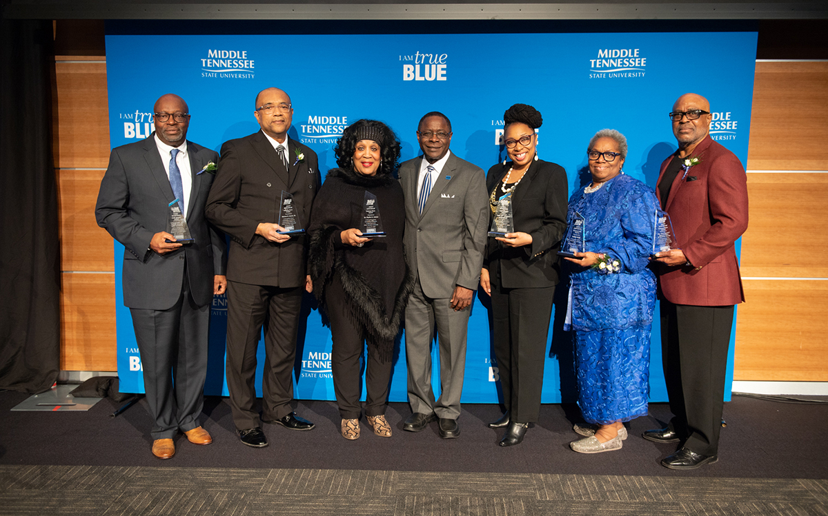 MTSU President Sidney A. McPhee, center, joins community "unsung hero" honorees at the 2020 Unity Luncheon Thursday, Feb. 20, in the MTSU Student Union Ballroom. From left are Ray Bonner; Marcus Lucas Sr.; Phyllis Adams; McPhee; Valerie Whitlow, who accepted for the late Leonora “Ms. Boe” Washington; Robbie Snapp; and Edmond Miller. (MTSU photo by James Cessna)