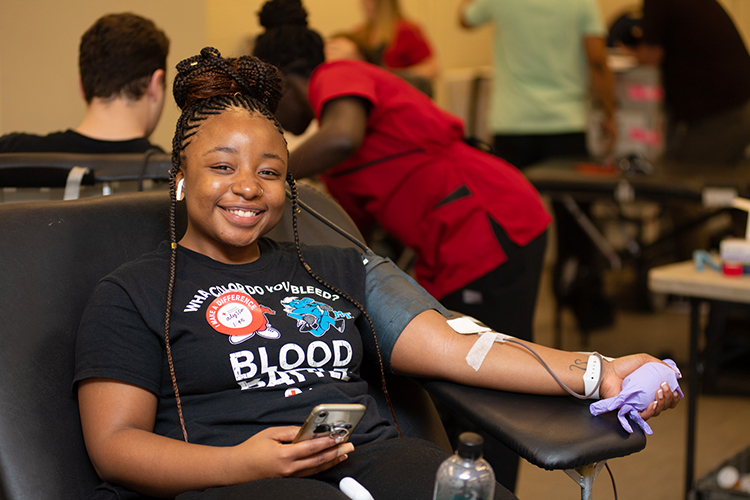 Alyssa Hawkins, a senior athletic training major, smiles while donating blood Feb. 10 in MTSU's Keathley University Center during the university's 2020 valentine blood drive. (MTSU photo by James Cessna)