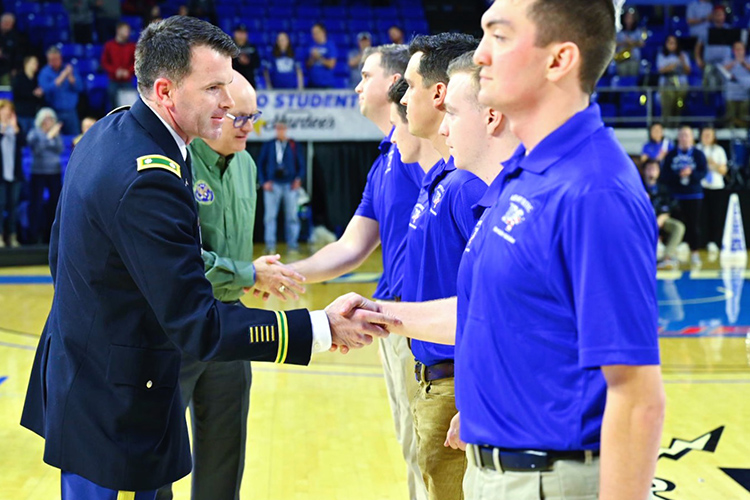 Army by Lt. Col. Carrick McCarthy, MTSU’s professor of military science and head of the Blue Raider Battalion, front left, and Andrew Oppmann, MTSU vice president for marketing and communications and Army Reserve ambassador, back left, congratulate newly contracted ROTC cadets during a special ceremony Jan. 30 at the MTSU Women’s Basketball’s veteran appreciation night at Murphy Center. (MTSU photo by Cat Curtis Murphy)