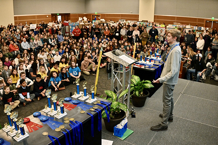 Maddox Prichard of Gallatin, Tenn., talks with a standing-room-only crowd in MTSU's Student Union during the 28th annual Invention Convention, held Feb. 27 at MTSU. Prichard, whose now-patented "Measuring Shovel" was the hit of the 2016 convention when he was a fourth grader, told his 828 fellow Middle Tennessee innovators to "never give up" in their quest to solve problems. (MTSU photo by J. Intintoli)