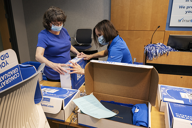 From left, Christi Farris, and Kay Gibbs, transcript clerks with the MTSU Registar’s Office, seal a True Blue Graduation Box for shipping to spring graduates Wednesday, May 20, inside the Student Services and Admissions Center. (MTSU photo by Andy Heidt)