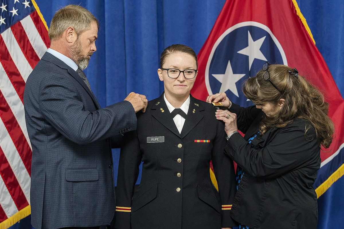 2nd Lt. Kaitlin Rupe, center, of Milton, Tenn., is pinned by her father, Scott Wallace, left, and stepmother, Lisa Wallace, Monday, May 11, during the second of three days of ROTC commissioning ceremonies by the MTSU Department of Military Science. Rupe earned her degree in aerospace flight dispatch. (MTSU photo by Andy Heidt)
