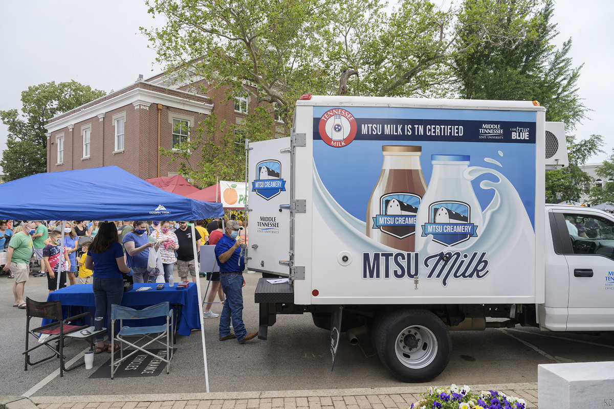 A number of Main Street Murfreesboro Saturday Market customers line up to purchase milk from the MTSU Creamery in this June 2020 file photo. MTSU sold out of milk in less than three hours in its first time to participate in the market, which runs from 8 a.m. to noon every Saturday until Oct. 30. (MTSU file photo by Andy Heidt)