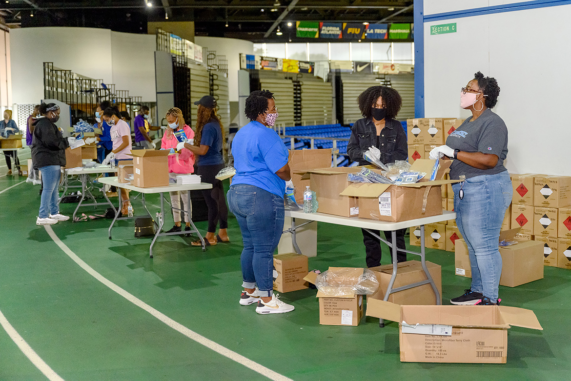MTSU student, faculty and staff volunteers work Friday, Aug. 21, on the track of Murphy Center assembling 5,000 COVID-19 care packages to distribute to student residence halls, academic colleges and high traffic areas. The graduate chapter of Alpha Kappa Alpha Inc. sorority partnered with the university to create the packages, which contained sanitizing items, masks and FAQ booklets about coronavirus precautions. (MTSU photo by J. Intintoli)