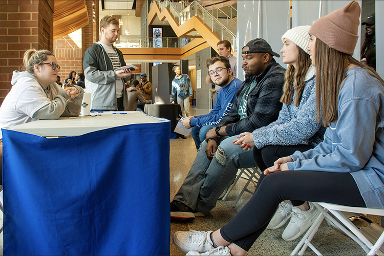 MTSU public relations students Hannah Field, left, of Murfreesboro, and Grant Thompson, standing, a Shelbyville, Tenn., native who now lives in Antioch, Tenn., talk with fellow students about the First Amendment in the Student Union during their award-winning November 2019 "1 for All @ MTSU: Freedom Comes First" public relations campaign. The "free lunch" event let participants choose whether to temporarily trade their five First Amendment freedoms for a chicken sandwich. The nine-member student team recently received two 2020 Parthenon Awards from the Nashville chapter of the Public Relations Society of America for their “shoestring budget” project. (Photo submitted)