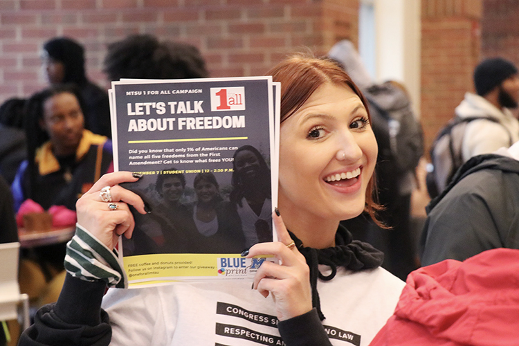 MTSU public relations student Katelyn Compton of Nolensville, Tennessee, displays one of the flyers from her class's award-winning "1 for All @ MTSU: Freedom Comes First" campaign inside the Student Union in this November 2019 photo. Compton, who received her bachelor's degree last December, and her eight classmates developed the plan to educate their peers about the First Amendment and recently received two 2020 Parthenon Awards from the Nashville chapter of the Public Relations Society of America for their “shoestring budget” project. (Photo submitted)