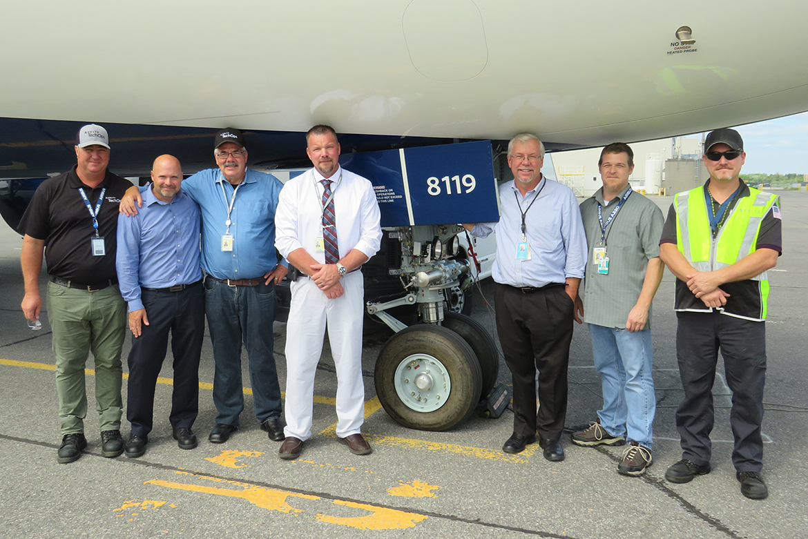 MTSU alumnus Chad Goddard, fourth from left, poses with co-workers next to a Delta Air Lines aircraft in Atlanta. Goddard, Delta's senior program manager for cabin maintenance, returned to MTSU after two decades to complete his bachelor’s degree in liberal studies in Spring 2019 and is currently working on his master’s in strategic leadership through MTSU Online. (Submitted photo)