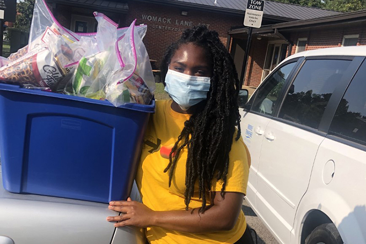Alyssa Poythress, a senior nutrition and food science major from Clarksville, Tennessee, displays a basket full of snack bags that she and other students put together for members of the MTSU community who are in quarantine due to the COVID-19 pandemic. (Photo submitted)