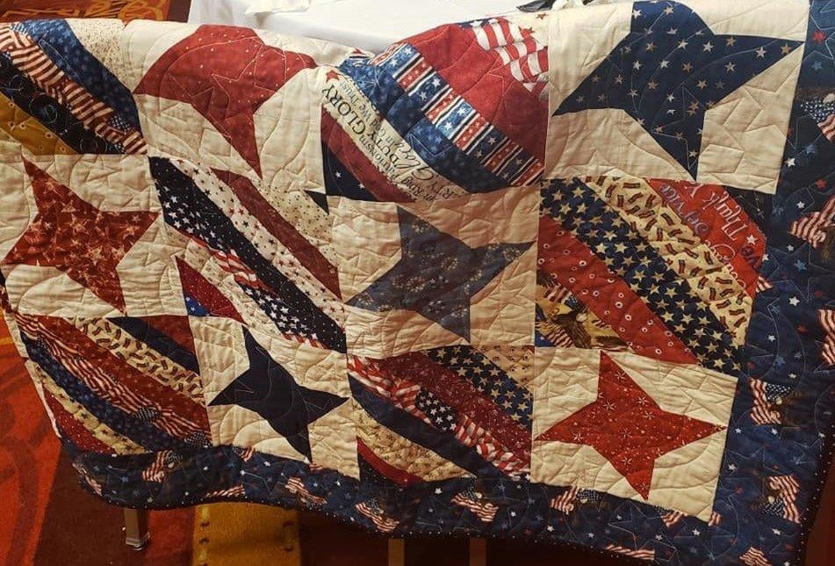 Jill Shaver of Murfreesboro made this Quilt of Valor presented to retired U.S. Air Force Lt. Col. Jacob R. McClenny on Oct. 3 as a birthday gift recognizing his heroism during World War II. MTSU’s Keith M. Huber, virtually, a retired U.S. Army lieutenant general with nearly 40 years of military service, and the Charlie and Hazel Daniels Veterans and Military Family Center, directed by Hilary Miller, presented McClenny with a special plaque. (Submitted photo)
