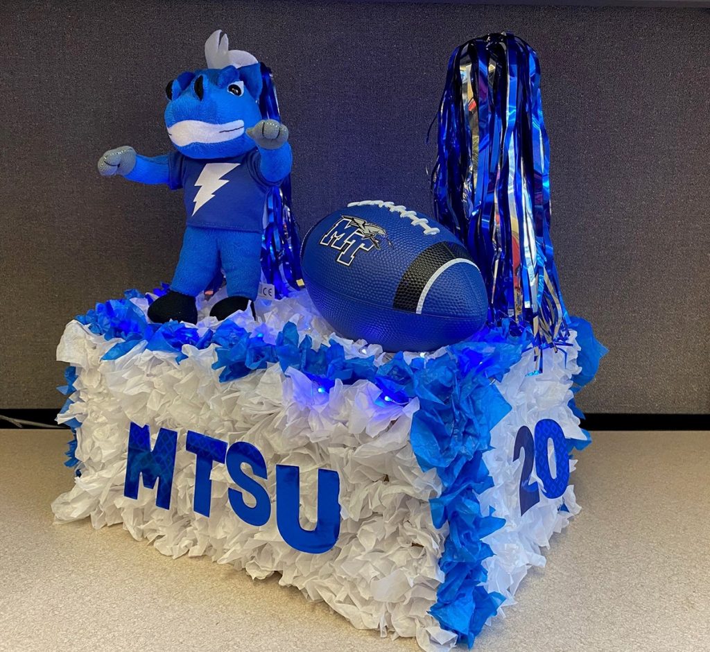 A stuffed animal version of MTSU mascot Lightning stands on a scaled-down replica of a Homecoming Parade float with True Blue pom-poms and MT football — one of about five dozen entries submitted by Blue Raider faithful for the virtual “MTShUbox Parade” in early October 2020. True Blue TV will broadcast this year’s rundown of entries at 1 p.m. Monday, Oct. 25. (Submitted photo)