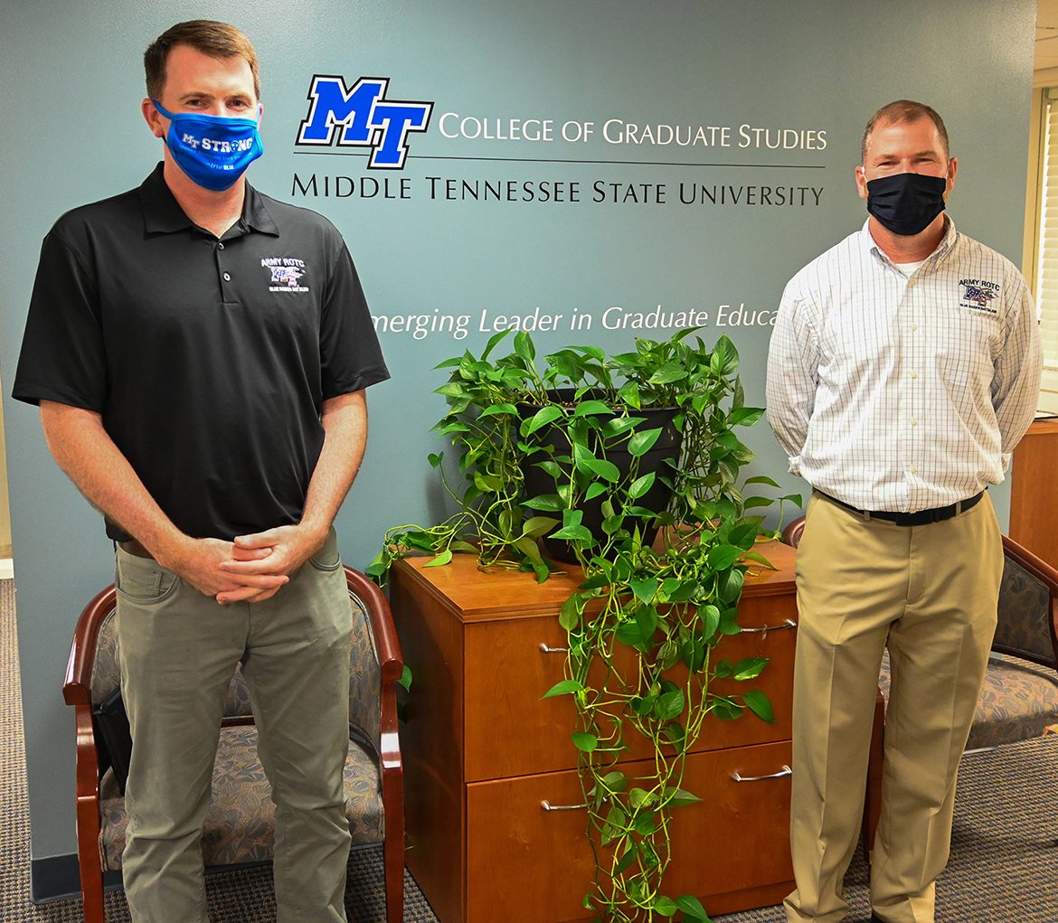 Lt. Col. Carrick E. McCarthy, left, and Marty Hill, right, of the Military Science Department pose in front of a wall decal in the College of Graduate Studies on Sept. 23, 2020. (MTSU photo by Stephanie Barrette)