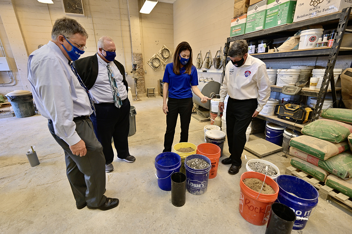 Heather Brown, second from right, MTSU concrete industry professor and former director of the School of Concrete and Construction Management, explains the ingredients from concrete mixes that were to be tested Monday, Nov. 9, inside a lab in the Voorhees Engineering Technology Building. Pictured, from left, are MTSU Provost Mark Byrnes; Bud Fischer, dean of the College of Basic and Applied Sciences; Brown; and Matt Crews, MTSU alumnus and CEO of the Music City Grand Prix. MTSU and the Grand Prix signed a memorandum of understanding Monday formalizing their partnership in support of the event, which includes the university’s concrete program producing eco-friendly race barriers for the August 2021 race. (MTSU photo by Andy Heidt)