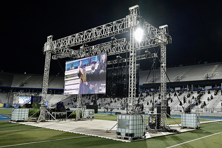 A large video screen displays one of the almost 400 graduates from May and August who chose to attend the Saturday, Nov. 21, outdoor Fall 2020 commencement ceremony at Floyd Stadium after MTSU moved its Spring and Summer 2020 commencements to a virtual format because of the COVID-19 pandemic. The three livestreamed ceremonies held Nov. 21 will re-air for 24 hours on Saturday, Nov. 28, on True Blue TV. (MTSU photo by Andy Heidt)