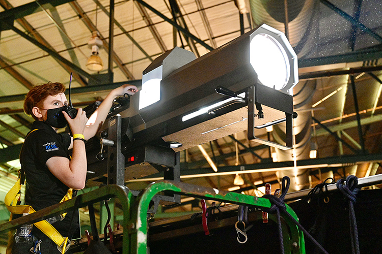 Erin Featherston, a Middle Tennessee State University theatre student, works a spotlight for the music video shoot of country music artists Reba McEntire and Cody Johnson’s new single “Dear Rodeo” at MTSU’s Tennessee Miller Coliseum in Murfreesboro, Tenn., on Oct. 1, 2020. (MTSU photo by Andy Heidt)
