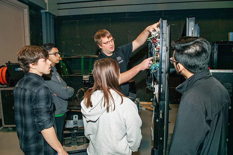 Mike Forbes, Middle Tennessee State University assistant director of technical systems, works with students to deconstruct LED video display panels for use on the set of MTSU Theatre’s production of “Joseph and the Amazing Technicolor Dreamcoat” on campus on March 15, 2018. Standing, from left, are Liam Nelson, Mina Ghattas, Sydney Penn, Forbes and Minh Phan. (MTSU file photo by Andy Heidt)