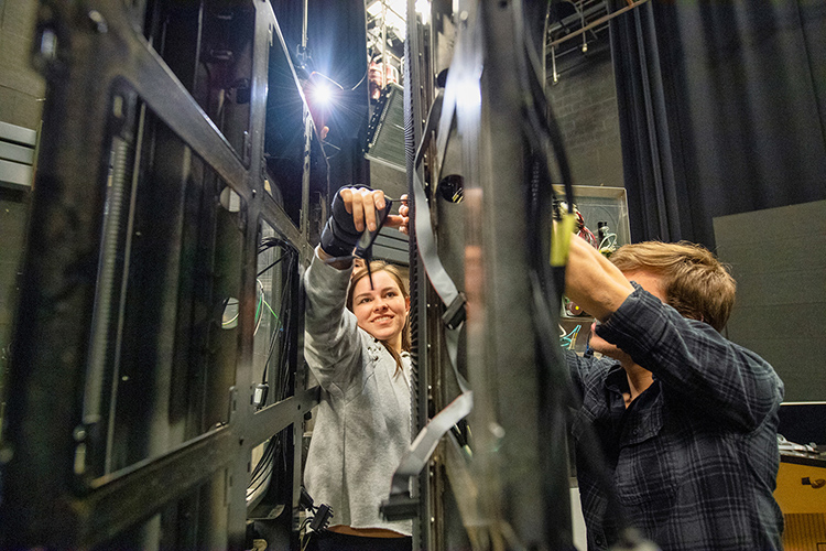 Middle Tennessee State University media arts students Sydney Penn, left, and Liam Nelson, right, deconstruct LED video display panels for use on the set of MTSU Theatre’s production of “Joseph and the Amazing Technicolor Dreamcoat” on campus on March 15, 2018. (MTSU file photo by Andy Heidt)