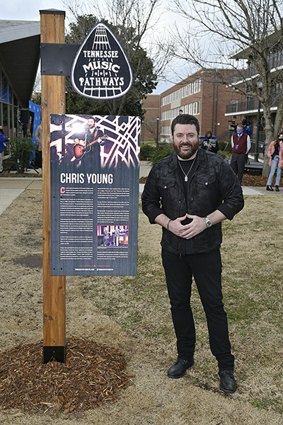 Multiplatinum country entertainer and Murfreesboro, Tenn., native Chris Young stands next to the Tennessee Department of Tourist Development's new Tennessee Music Pathways marker unveiled Wednesday, Jan. 27, outside the new MTSU learning lab and live entertainment venue that bears his name. The sign, revealed during a special livestreamed ceremony outside the Chris Young Cafe, details the former MTSU student's accomplishments. Young's marker for the statewide initiative, which identifies, interprets, promotes and preserves Tennessee’s musical heritage, is the second on the MTSU campus; the Center for Popular Music at MTSU, located inside the Bragg Media and Entertainment Building, received its Pathways marker in November 2018. (MTSU photo by Andy Heidt)