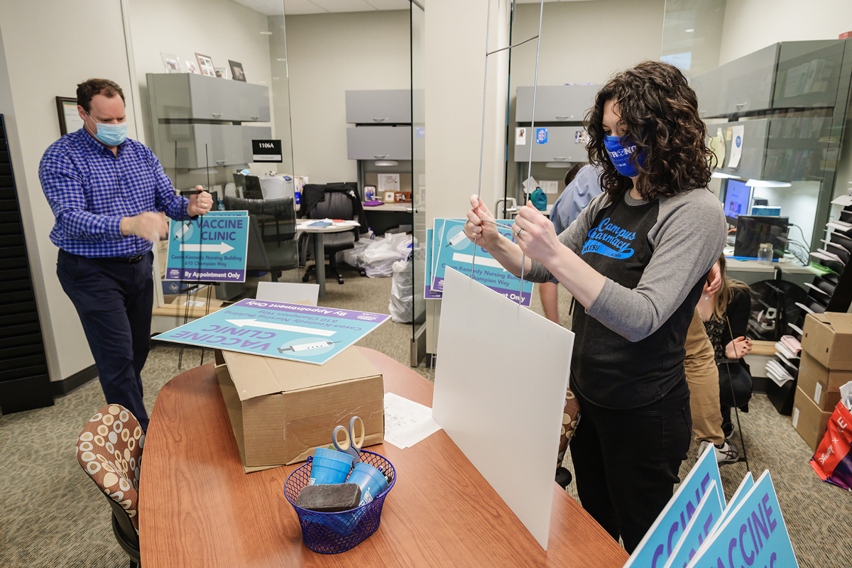 MTSU Health Services Director Rick Chapman, left, and Health Promotion Director Lisa Schrader prepare some of the 27 yard signs that were placed across campus Wednesday, Feb. 24, promoting the free COVID-19 vaccine clinic that will be offered starting Feb. 25 by the School of Nursing in Cason-Kennedy Nursing Building, in partnership with the Rutherford County Health Department. Vaccines will be administered on Thursdays and Saturdays. (MTSU photo by Andy Heidt)