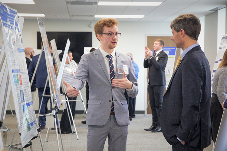 Middle Tennessee State University Undergraduate Research Experience and Creative Activity grant student Aric Moilanen, left, shares his research with Tennessee state Rep. Charlie Baum, right, at the Posters at the Capitol event in February 2020 at the Cordell Hull Building in Nashville, Tenn. (MTSU photo by Casey Penston)
