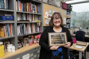 MTSU chemistry professor Judith Iriarte-Gross, recipient of the 2020 Woman of Achievement Award from the Women in Higher Education in Tennessee, holds the award inside her office in the Science Building. (MTSU photo by Andy Heidt)