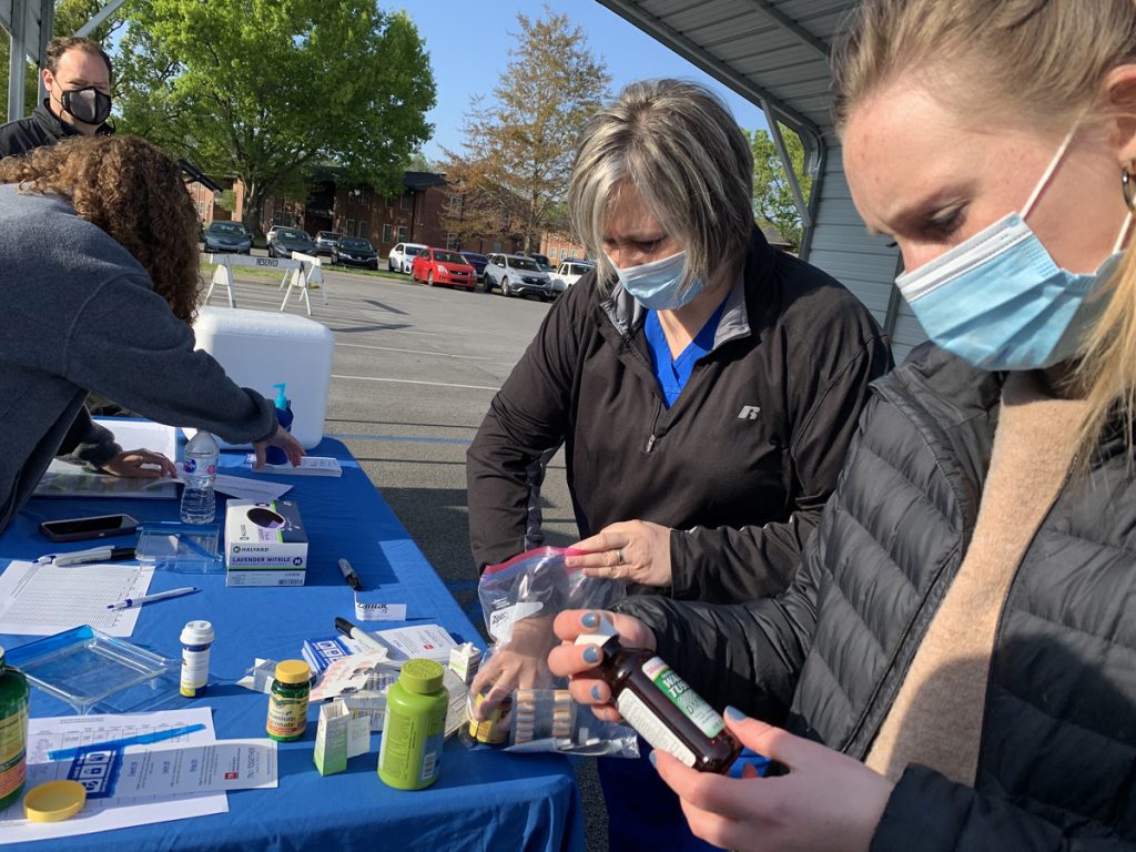 MTSU Health Services nurse Heather Ashby, second from right, empties some of her family’s old medications out for university officials to count as part of the spring MTSU Drug Take-Back Day event Thursday, April 22, outside the Health, Wellness and Recreation Center on Blue Raider Drive. Lipscomb University fourth-year pharmacy student Abby Sparkman, right, studies a bottle of old medicine — part of 71.7 pounds collected during the 5½- hour drive before adding it to the collection list. Also pictured are Pharmacist Tabby Ragland and Rick Chapman, Health Services director. (MTSU photo by Randy Weiler)