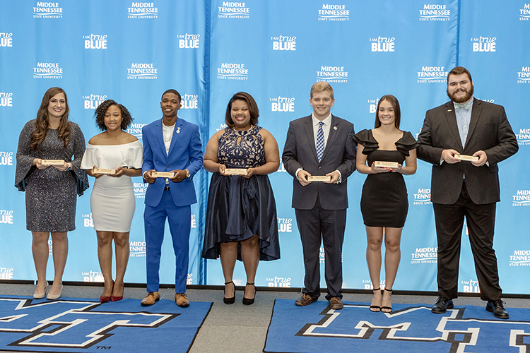 Chelseah Moore, second from left, joins other award winners at the 2019 Student Government Association Banquet in the Student Union Ballroom. Others include, from left, Delanie McDonald, Moore, J.C. Mason, Deja Watts, Preston George, Alex Revor and Nate Parris. (MTSU photo by J. Intintoli)